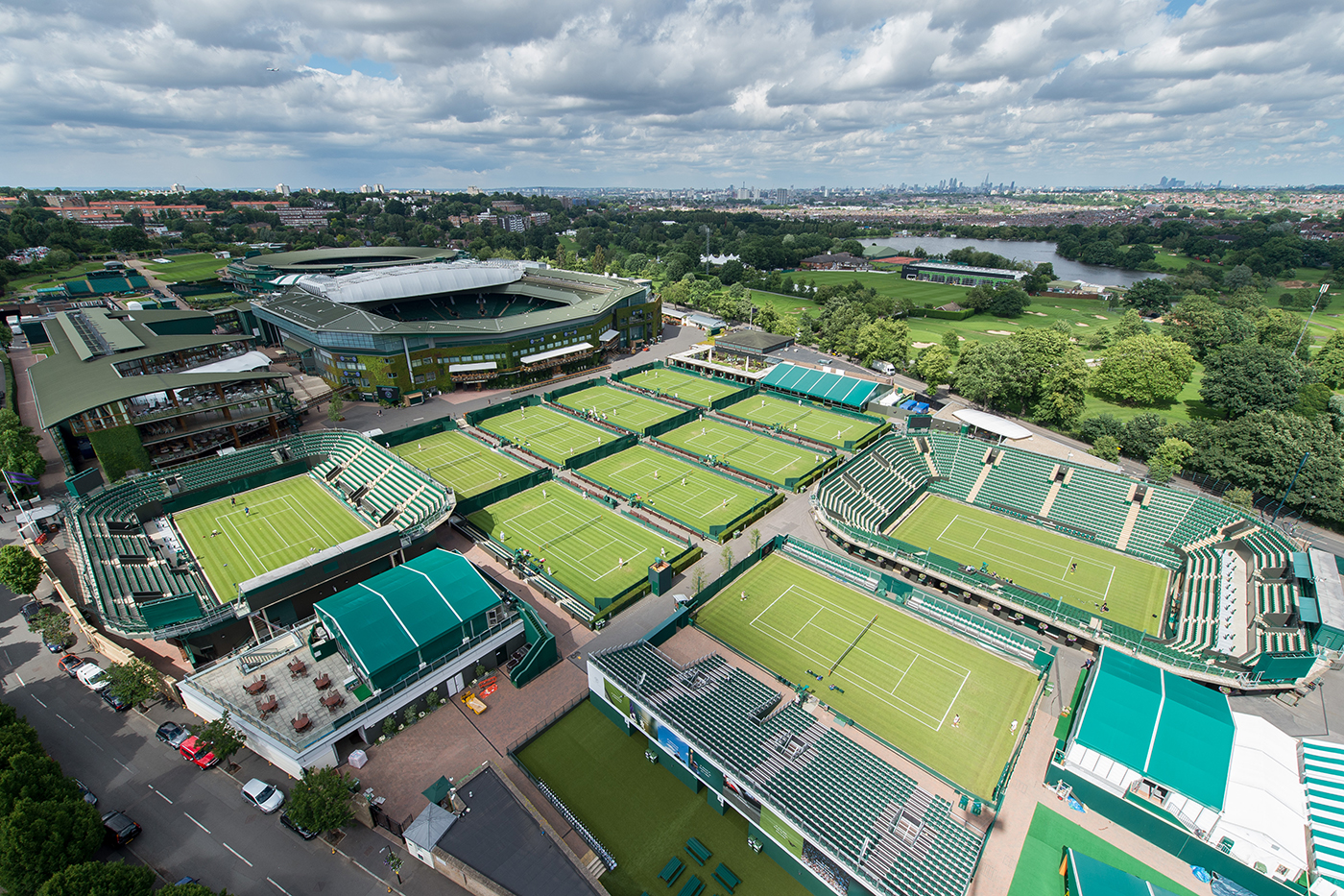 View from a high level camera over the outside courts to Centre Court and The Clubhouse. The Championships 2016 at The All England Lawn Tennis Club, Wimbledon. Day -3 Friday 24/06/2016. AELTC/Joe Toth